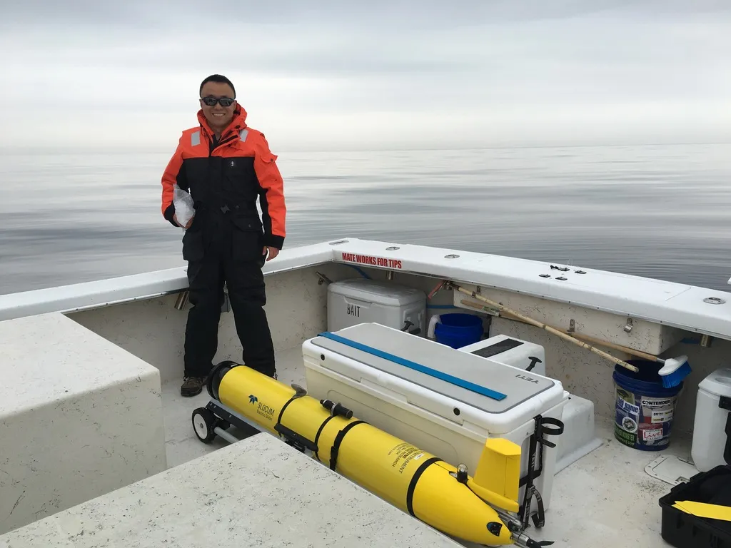 Donglai Gong with a Slocum glider on deck before deployment.