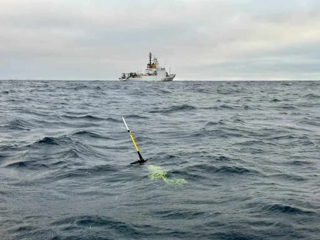 A glider at the surface of rough Nordic seas, with a research vessel standing by in the distance.
